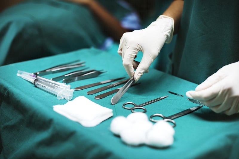 operating room nurses lays out surgical supplies